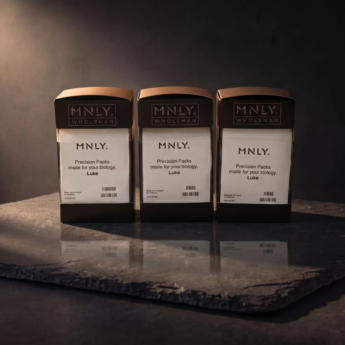 MNLY Precision Supplements packs on slate